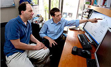 Here is Stanford University professor Stephen Quake, PhD, (left) discussing his possible disease risks with his cardiologist, Euan Ashley, M.D. (right), based on an assessment of his whole genome sequence. (photo by Norbert von der Groeben/Stanford University School of Medicine)