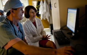 Genetic testing is now part of care protocols in the cardiac catheterization laboratory at the University of Florida Clinical and Translational Science Institute. In this photo, R. David Anderson, M.D., and Julie A. Johnson, Pharm.D., review an alert that appears in a cardiac patient's electronic medical record when genetic results suggest a prescribed drug may not be effective. (Photo by Jesse Jones/University of Florida.)