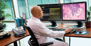 Pictured above is a digital pathology workstation that was designed by Omnyx, LLC, a joint venture of GE Healthcare and the pathology department at the University of Pittsburgh Medical Center (UPMC). Digital pathology systems scan specimens in-depth to include each layer of cells, allowing the pathologist to read and diagnose specimen samples from a computer screen. (Photo copyright GE Healthcare.)