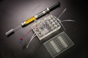The lab-in-a-needle device (pictured above) involves two chips. One has a miniature motor and microfluidics to handle sample preparation. The other chip amplifies the samples, according to researchers at Houston Methodist, who collaborated with Nanyang Technological University (NTU) and the Singapore Institute of Manufacturing Technology (SIMTech), two major Singapore institutions, to develop the device. The portable lab-in-a-needle instrument could make possible instant results from routine lab tests, the organizations’ research suggests. (Photo copyright: Houston Methodist.)