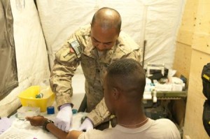 U.S. Army Spc. John Eric Lawrence Macam, left, with Charlie Company, 201st Brigade Support Battalion, 3rd Brigade Combat Team, 1st Infantry Division draws blood from a donor during the walking blood bank at Forward Operating Base Apache in Zabul province, Afghanistan, June 21, 2013. The walking blood bank is designed to supply deployed soldiers who may be in need of blood with the best possible donor. (U.S. Army photo by Sgt. Michael Needham/Released.)