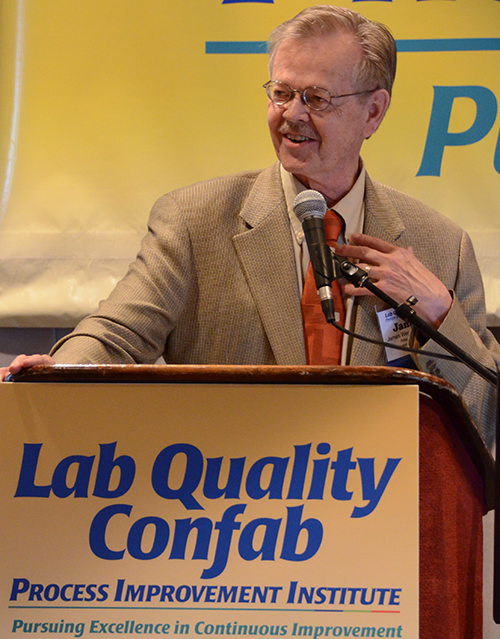 Sten Westgard of Westgard QC at the podium at LAB QUALITY CONFAB meeting held by THE DARK REPORT.