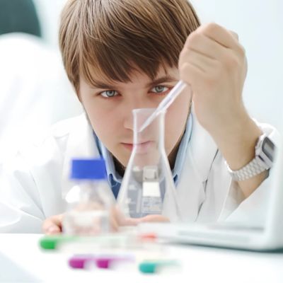 Young medical scientist working in lab research with tubes and notebooks